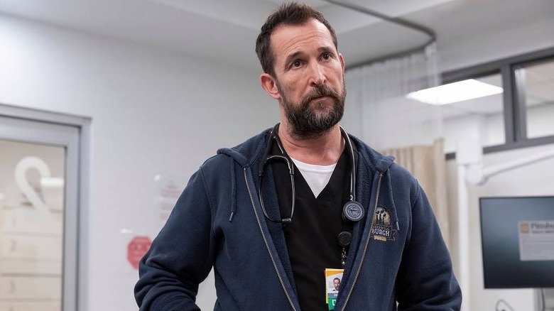Robby in a hoodie looking ahead wearing his stethoscope on The Pitt