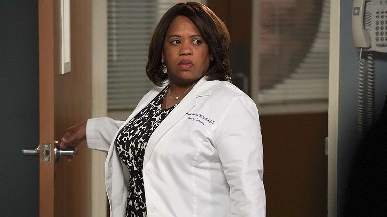 Miranda in her white coat looking over her shoulder in a doorway on Grey's Anatomy
