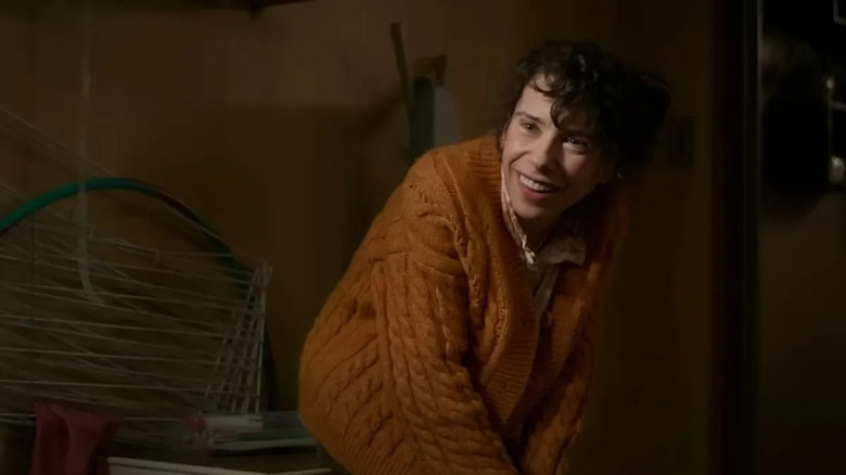 Laura crouching and smiling in Bring Her Back