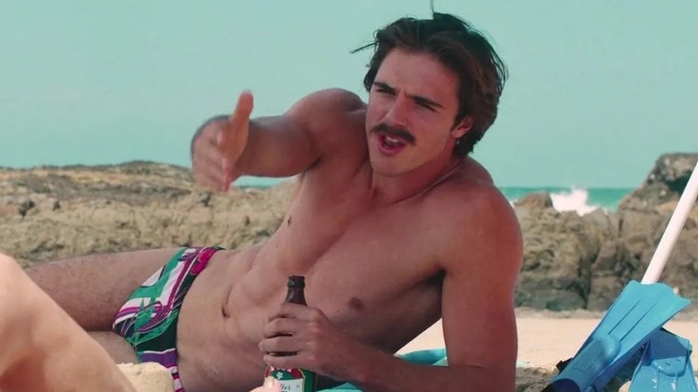 Rooster drinking a beer on the beach in Swinging Safari (2018)