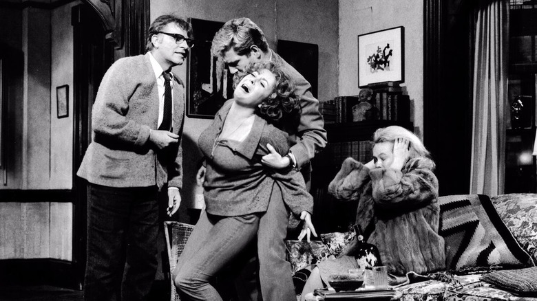 George and Nick holding Martha in front of a frightened Honey in Who's Afraid of Virginia Woolf?