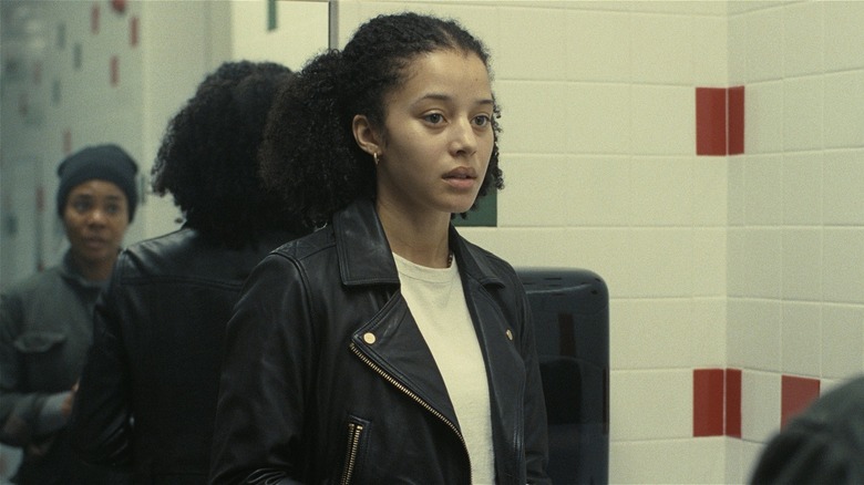 Willa being confronted in a bathroom in "One Battle After Another" (2025)