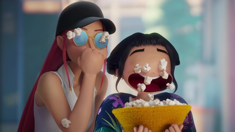 Zoey cries popcorn into a bowl that Mira eats from in "KPop Demon Hunters" (2025)