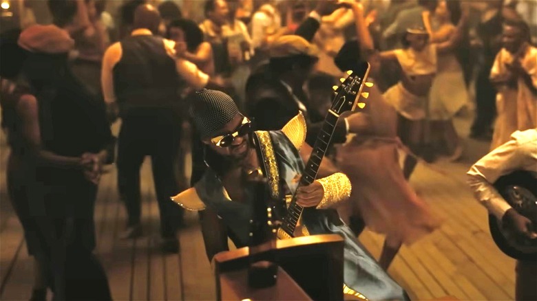 A guitarist from the future playing at the juke joint in "Sinners" (2025)