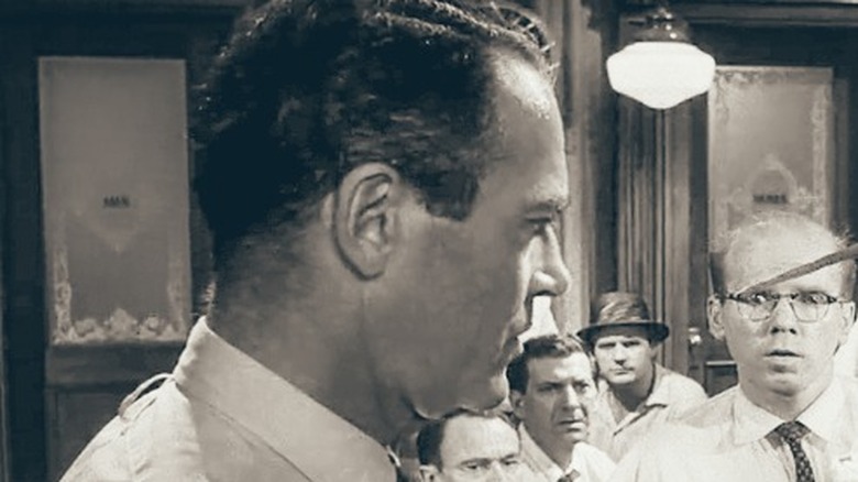 A juror holding a knife to another juror