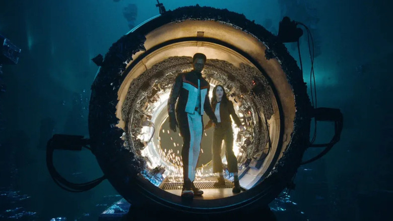 Mister Terrific and Lois Lane traveling through a dimensional portal in "Superman"
