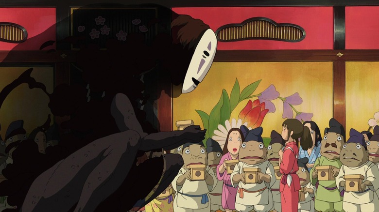 Chihiro confronts No-Face as spirits watch in "Spirited Away" (2001)