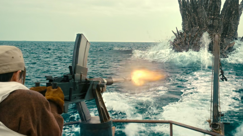 Man fires at Godzilla rising from the ocean in Godzilla Minus One