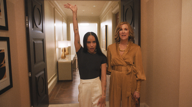 Zoe raising an arm next to Patti in a hotel hallway on The Studio