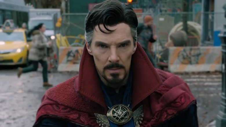 Doctor Strange with people running behind him in "Doctor Strange in the Multiverse of Madness" (2022)