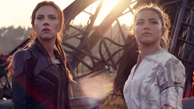 Natasha and Yelena standing outside at sunset in "Black Widow" (2021)