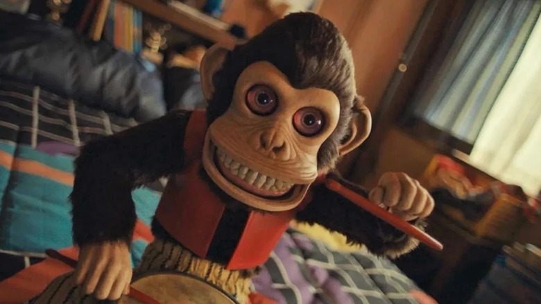 The Monkey sitting on a bed