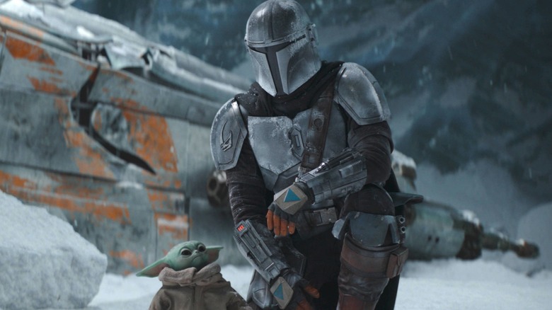 The Mandalorian and Grogu standing in snow in "The Mandalorian."