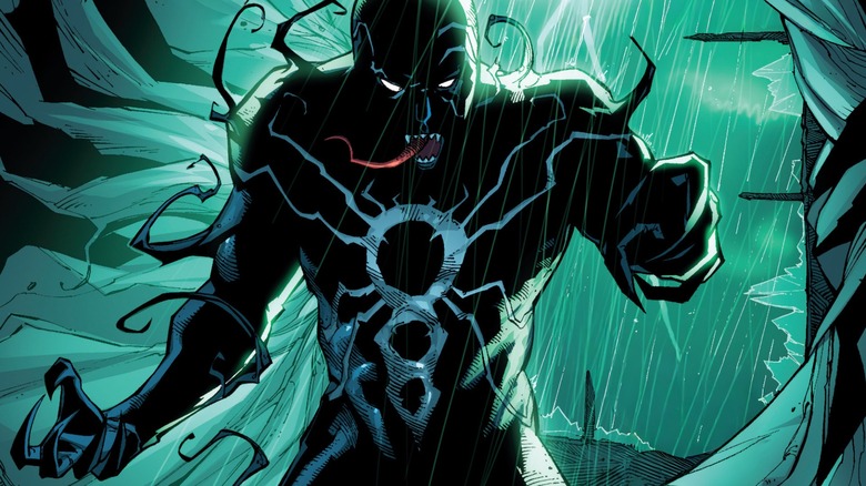 Poison standing menacingly in the rain with his tongue hanging out
