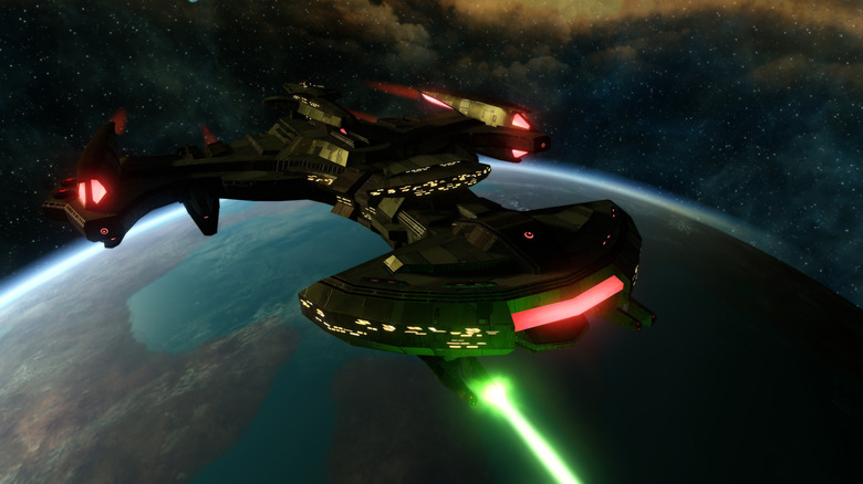The Negh'Var flies over a planet and fires an energy weapon in Star Trek Online