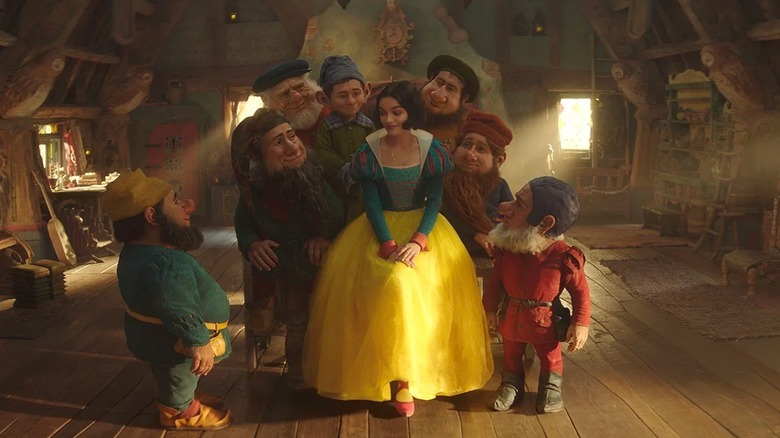 Snow White surrounded by her dwarf friends in Snow White (2025)