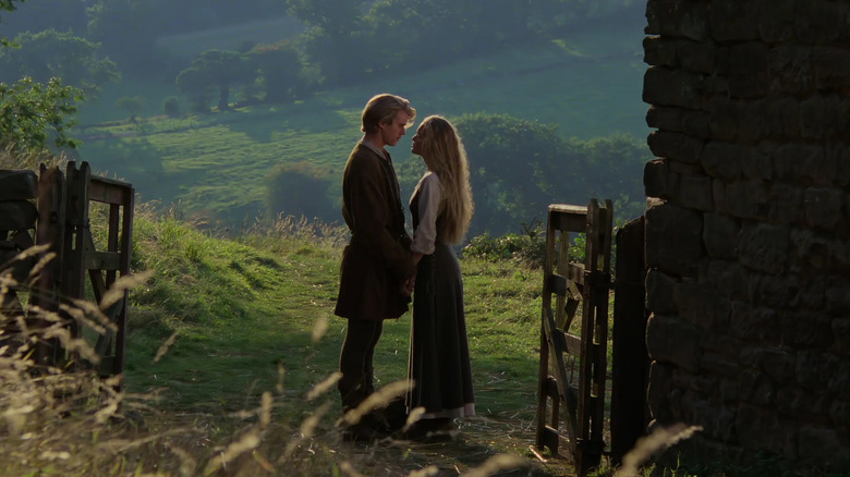 Westley and Buttercup holding hands outside in 