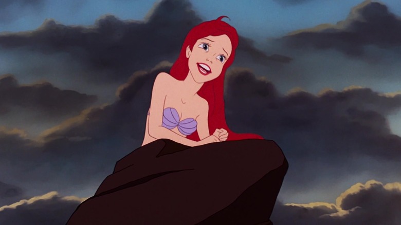 Ariel climbs on a rock and sings in "The Little Mermaid" (1989)