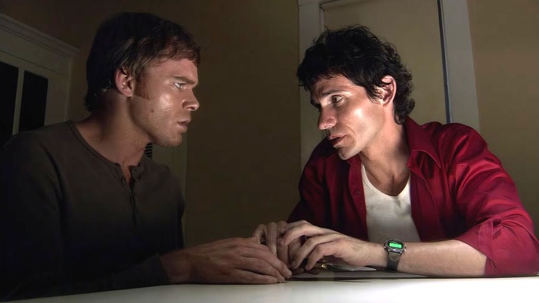 Dexter and Brian sitting at a table in "Dexter."