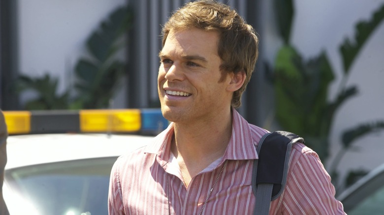 Dexter smiling, outside, wearing a striped shirt, on Dexter