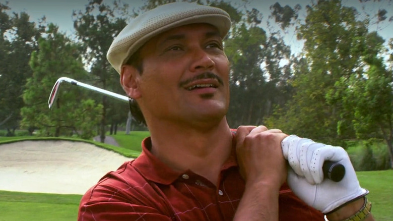 Miguel holding a golf club in Dexter.