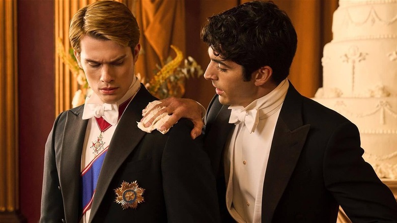 Alex smushing frosting on Henry's shoulder in Red White & Royal Blue