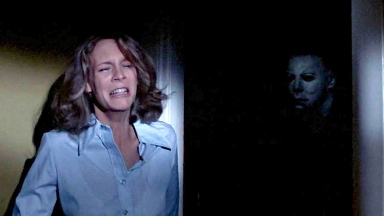 Laurie Strode cowering from Michael Myers in Halloween