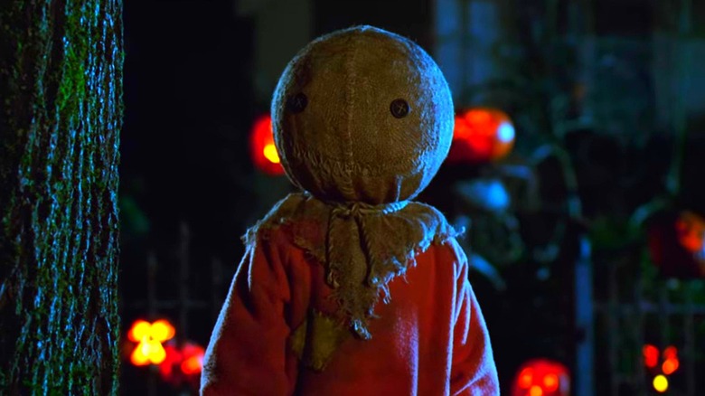 Sam standing next to a tree at night in Trick 'r Treat