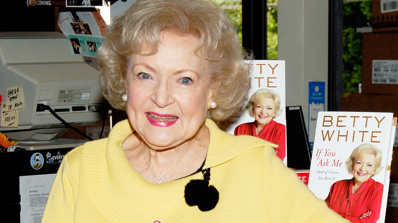 Betty White standing in front of her books