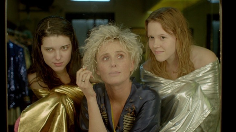 Golden, Krysia, and Silver looking in a dressing room mirror in The Lure
