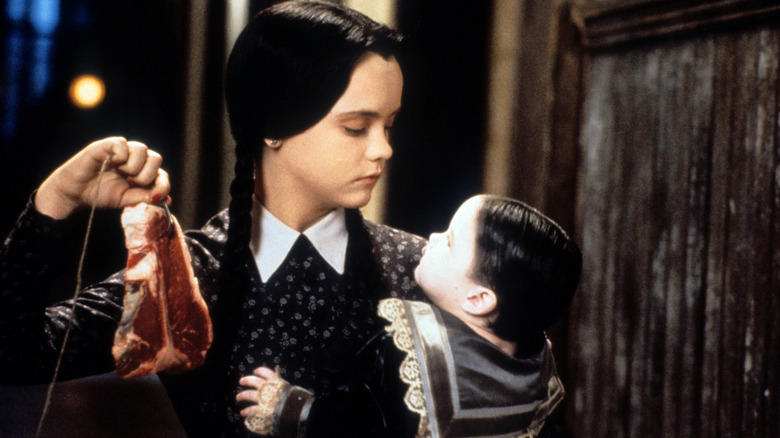 Wednesday Addams feeds Pubert a steak in 'Addams Family Values' (1993)