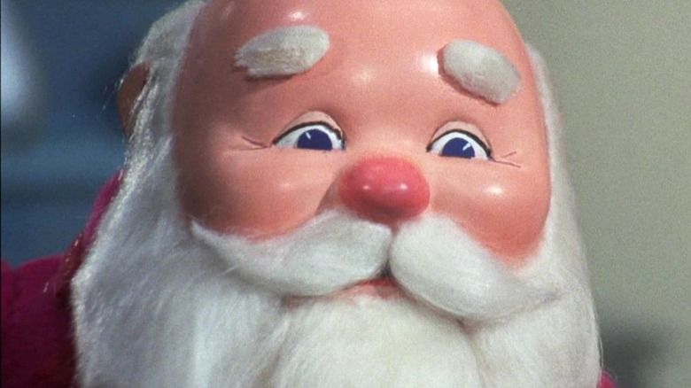 Santa smiles with a glowing nose