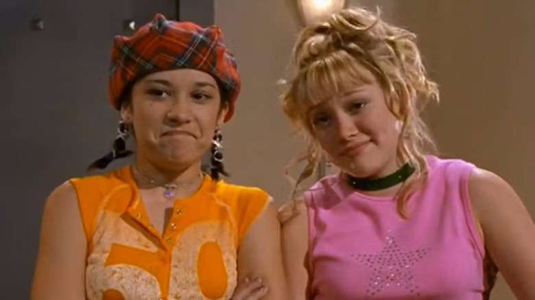 Miranda (Lalaine) and Lizzie (Hilary Duff) smiling awkwardly at something off screen