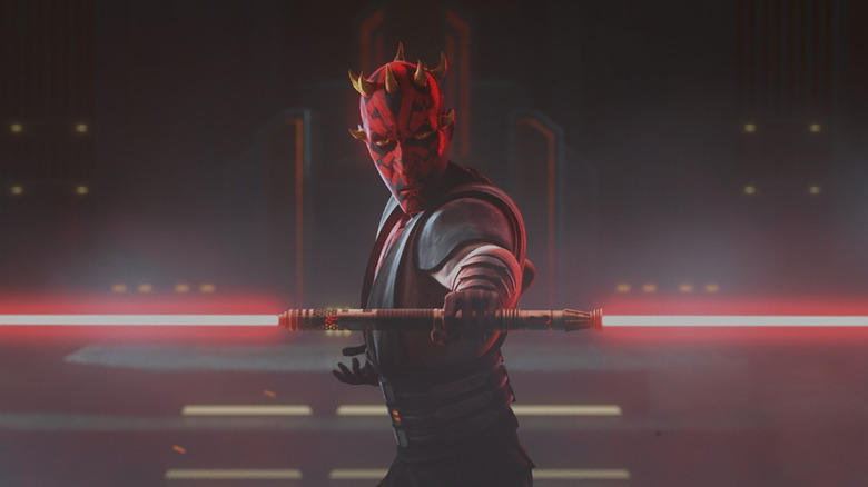 Darth Maul (Sam Witwer) standing, lightsaber ready, preparing to duel Ahsoka (Ashley Eckstein)