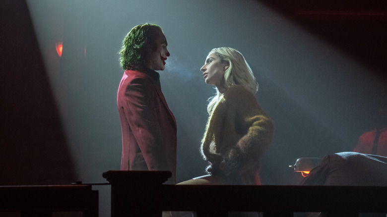 Joker and Lee sing under a spotlight in "Joker: Folie a Deux"