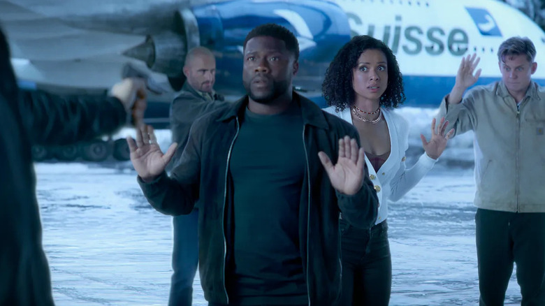 Cyrus, Abby, and Magnus stand on a snowy runway in "Lift" (2024)