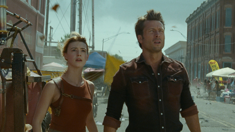 Kate and Tyler watch as a tornado approaches in "Twisters" (2024)