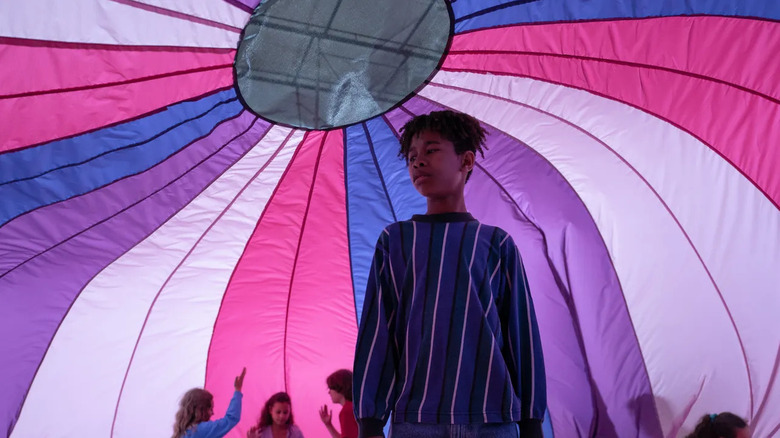 Young Owen under a parachute in "I Saw the TV Glow" (2024)