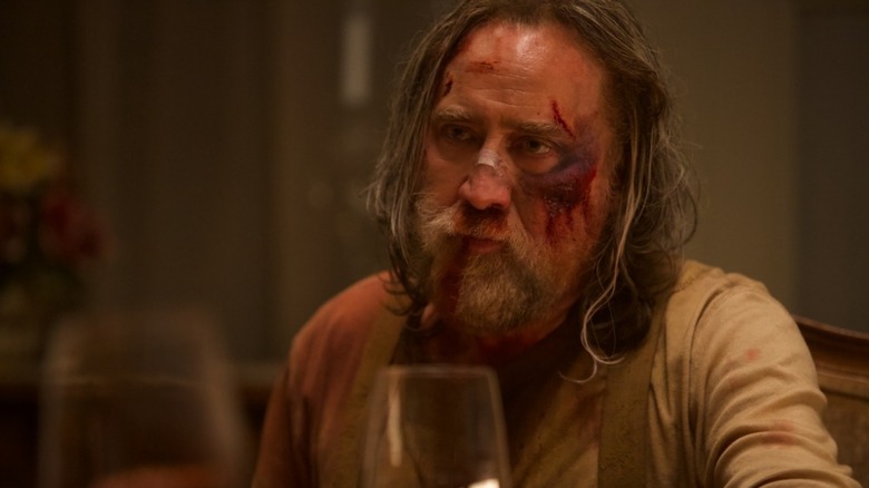 Rob sits for drinks with a bloodied face in "Pig" (2021)