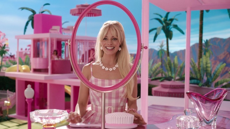 Barbie looks through her empty Dream House mirror in "Barbie" (2025)