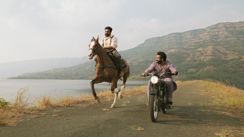 Ran rides a horse and Bheem rides a motorcycle in "RRR" (2022)