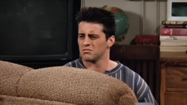 Joey looks up from the couch sleepily on "Friends" (1994-2004)