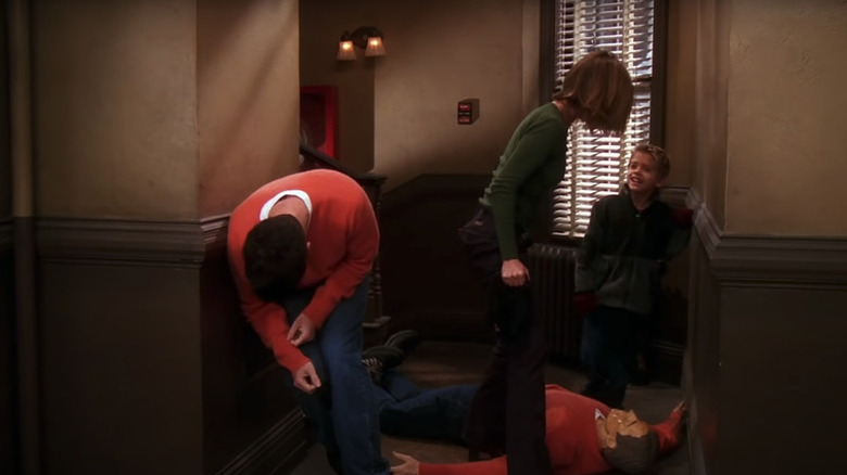 Ross keels over laughing as Rachel stands over a dummy dressed to look like him on "Friends" (1994-2004)