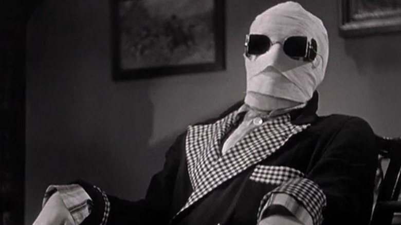 Griffin laughs in his seat in "The Invisible Man" (1933)