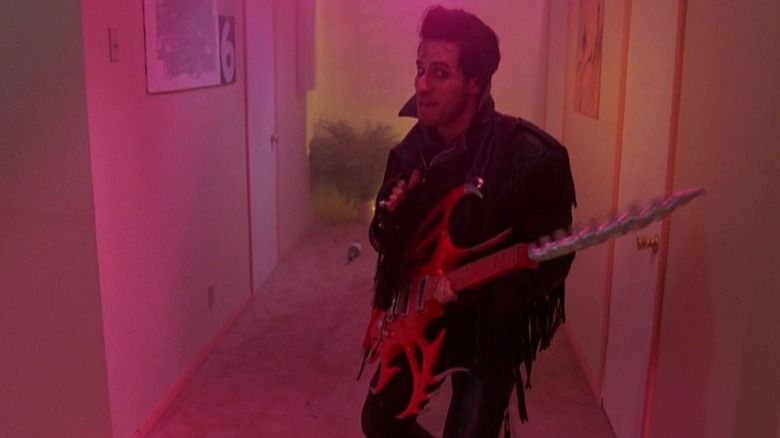 The Driller Killer holding his guitar-drill