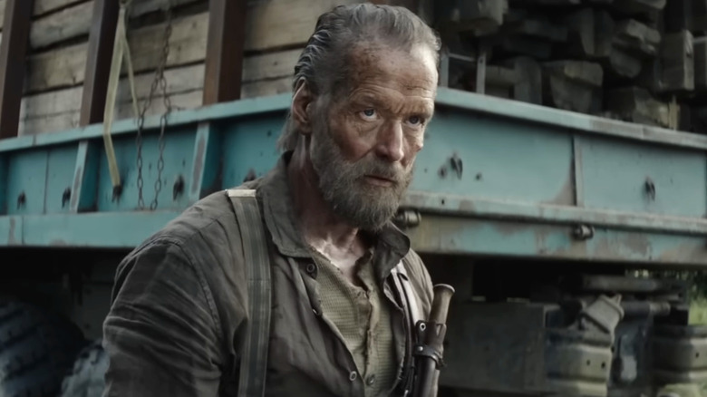 Aatami Korpi standing by his truck in Sisu: Road to Revenge