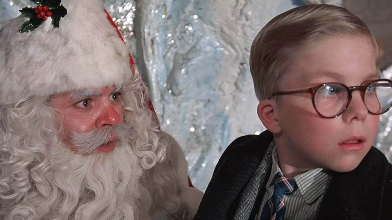 Ralphie looks away from Santa while sitting on his lap