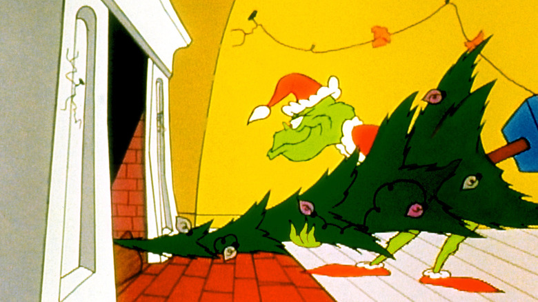 The Grinch shoves a stolen tree up a chimney