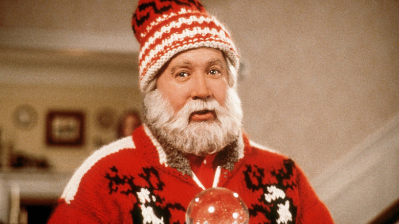 Scott Calvin in full Santa form holding a snow globe