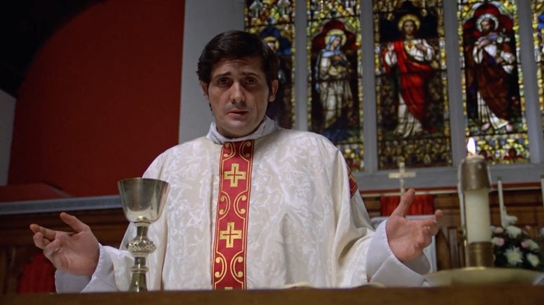 Father Karras preaching from the pulpit